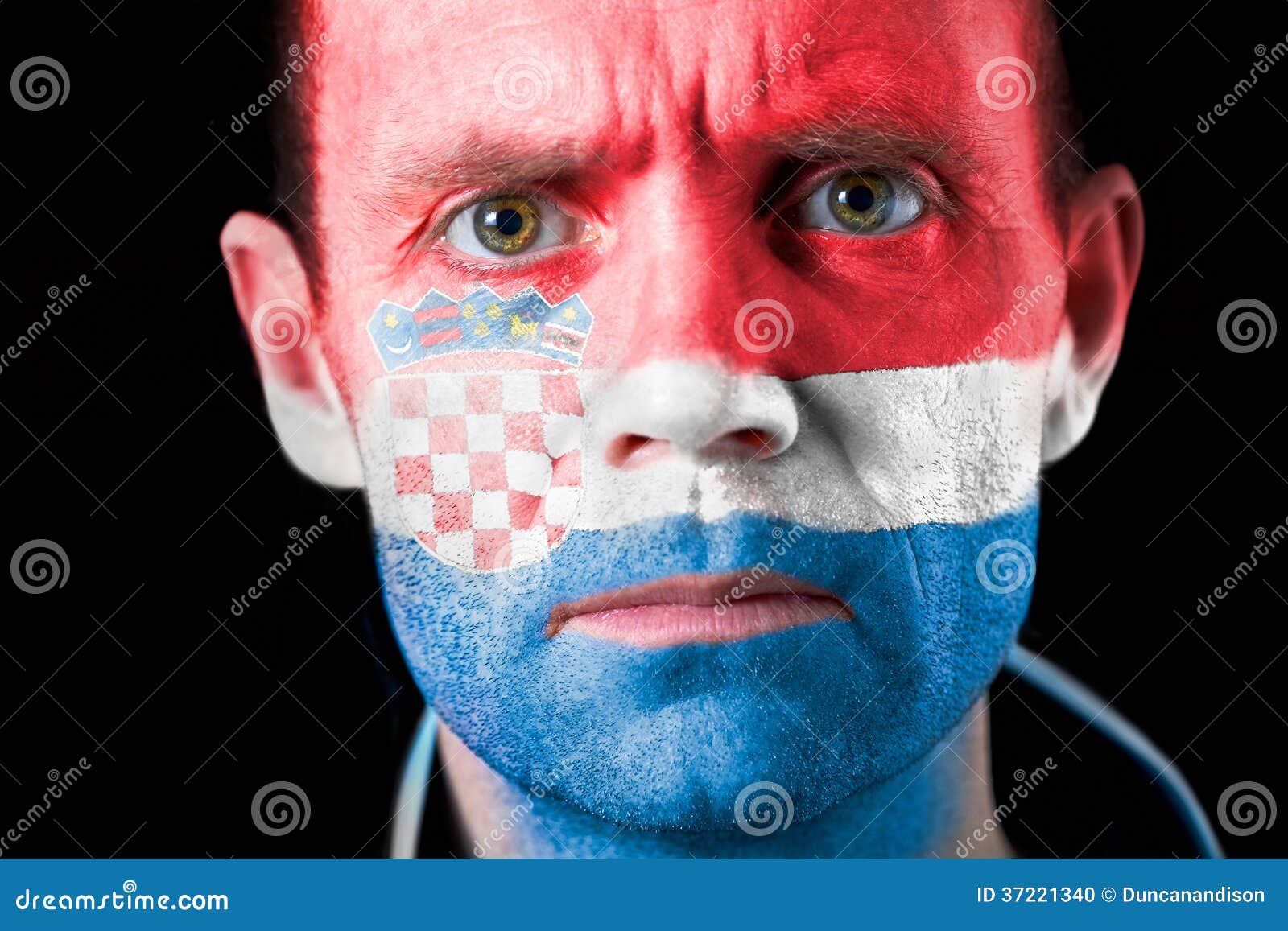 Football Fans. An intense stare from a football fan with their face painted with the Croatian flag.