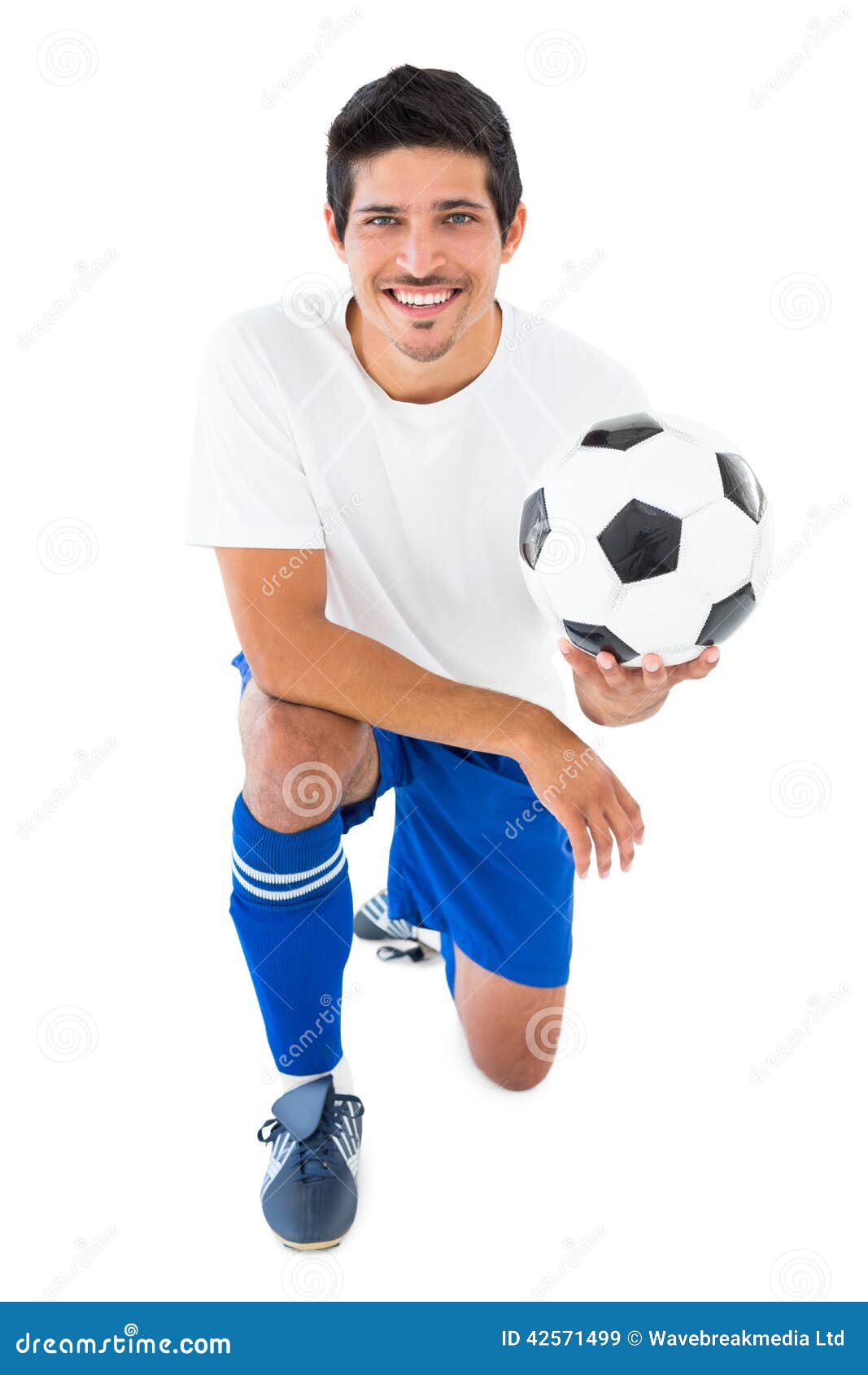 Football Player in Blue Kneeling with Ball Stock Image Image of