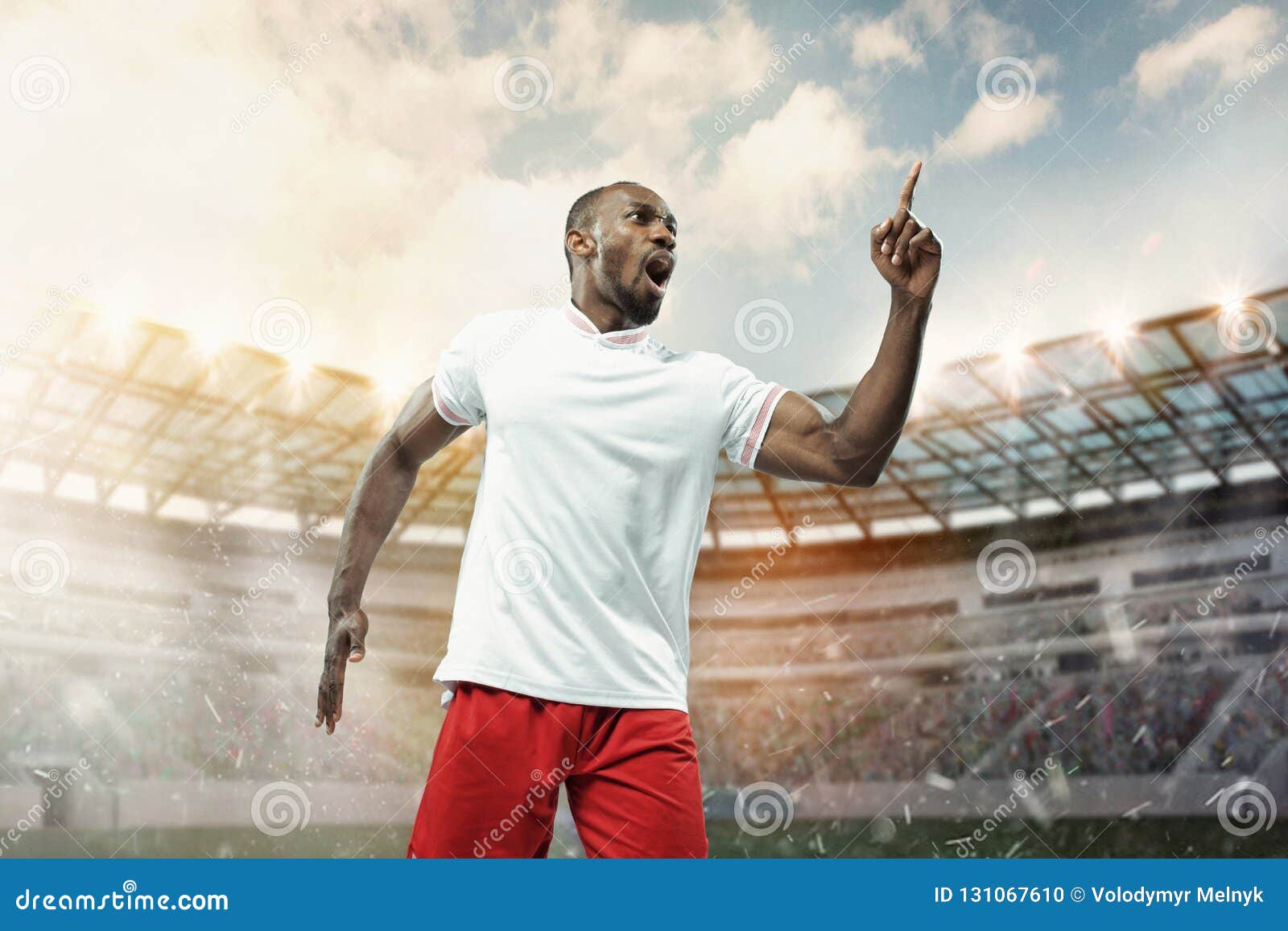 The Football Player in Motion on the Field of Stadium Stock Photo ...