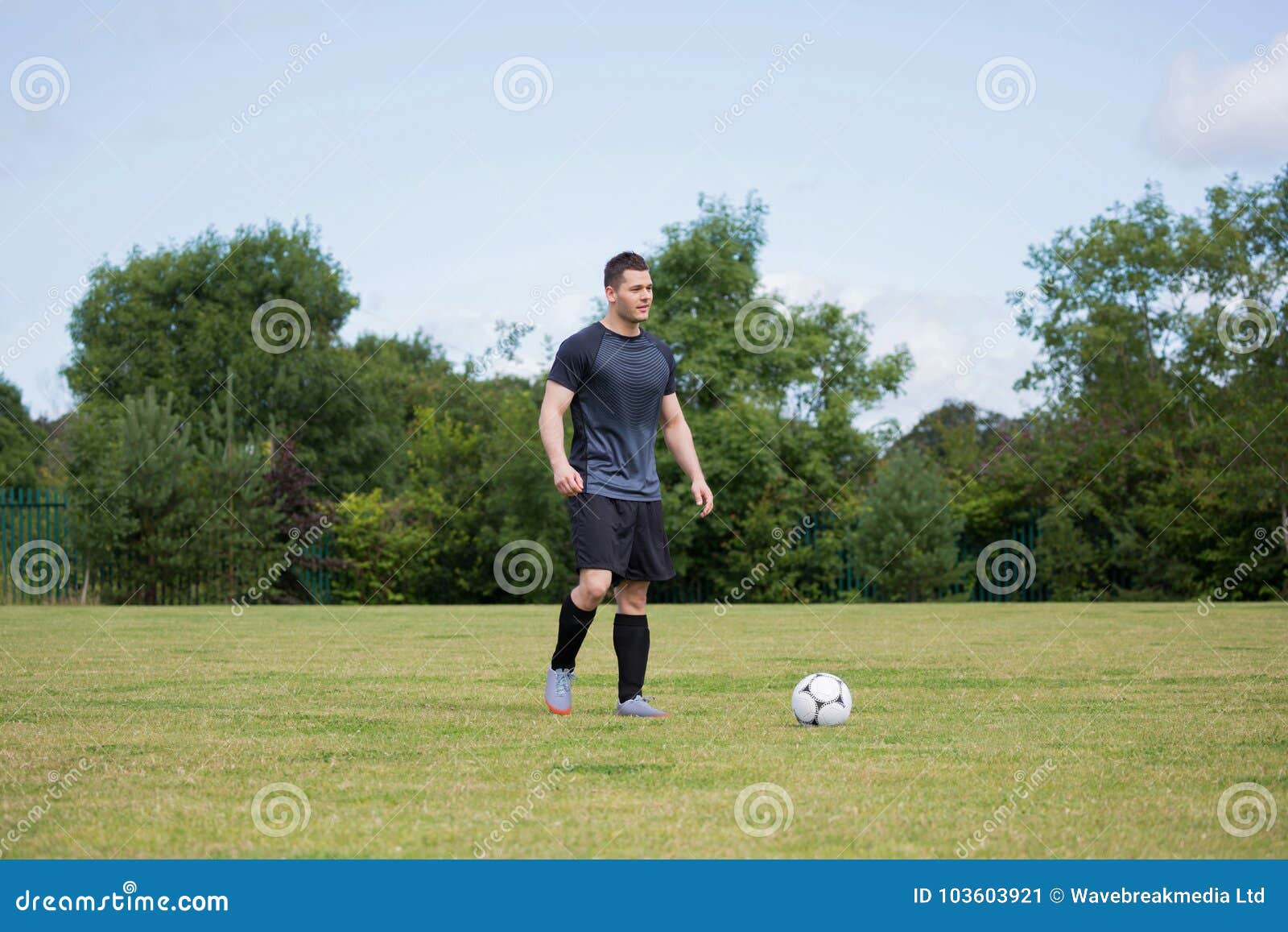 Football Player Playing Soccer in the Ground Stock Image - Image of