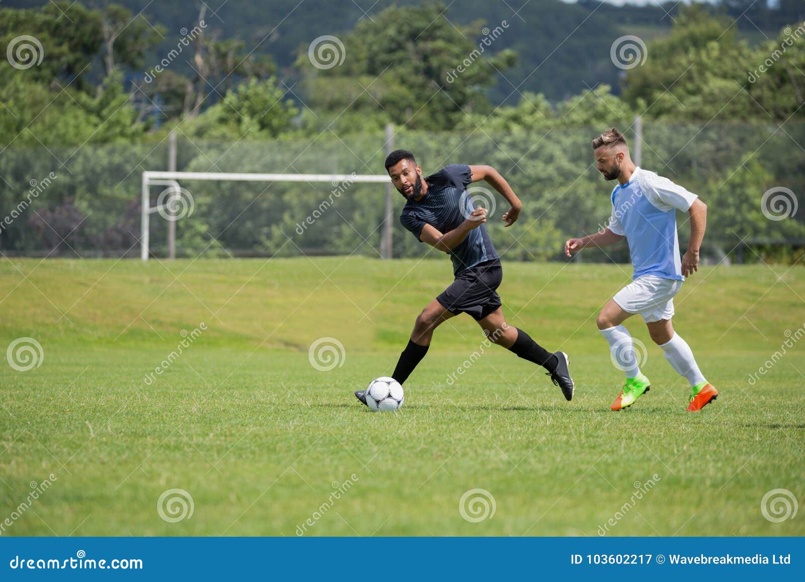 Football Players Playing Soccer in the Ground Stock Image - Image of