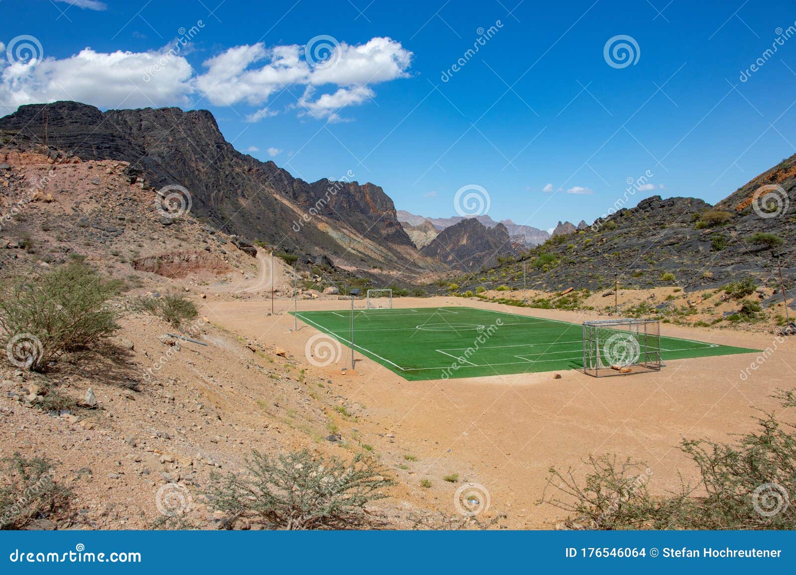 football and soccer field inside mountain and valley along wadi sahtan road in al hajir mountains between nizwa and mascat in oman