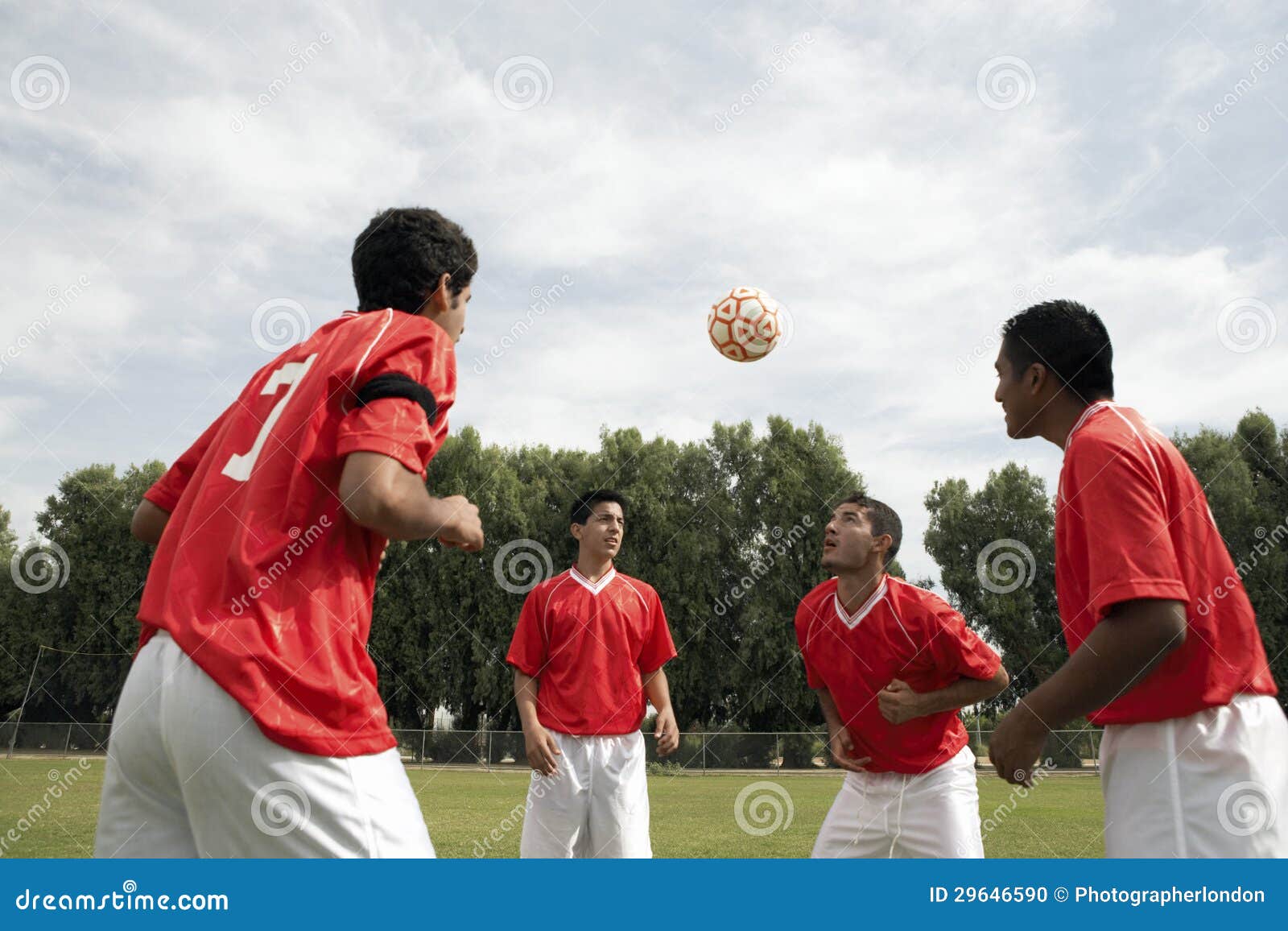 footballers heading the ball