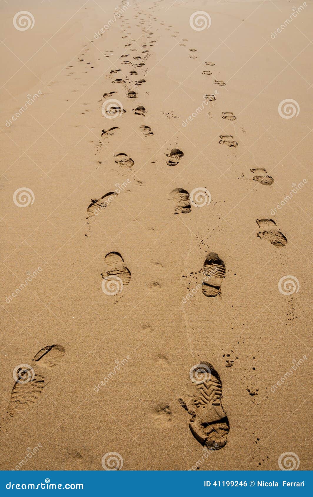 Footprints of Hiking Boots on the Sand of a Beach. Stock Photo Image