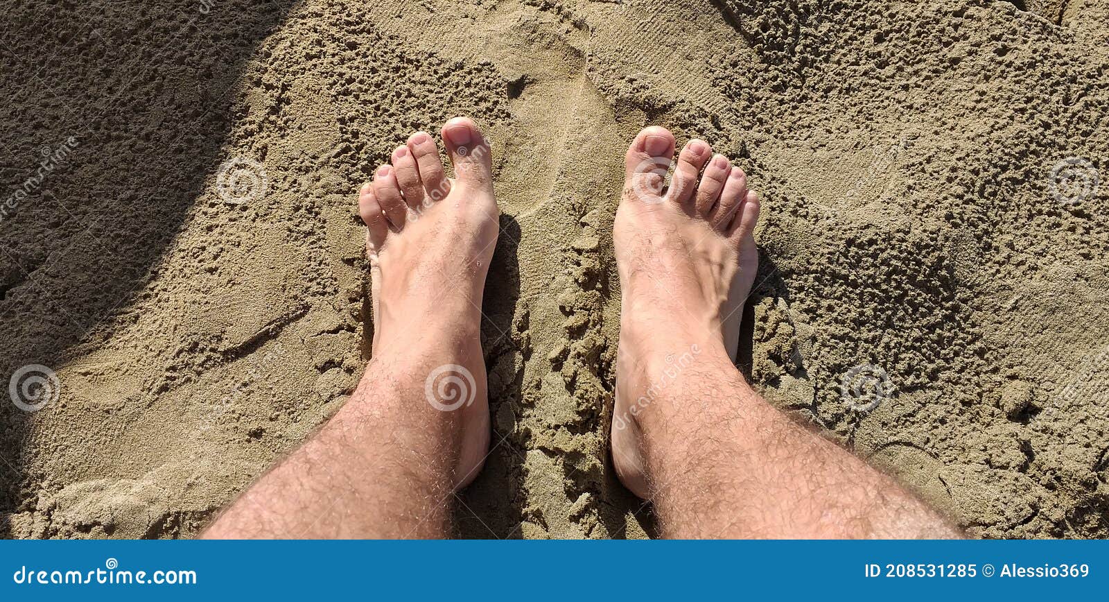 footprints of human feet on the warm sand