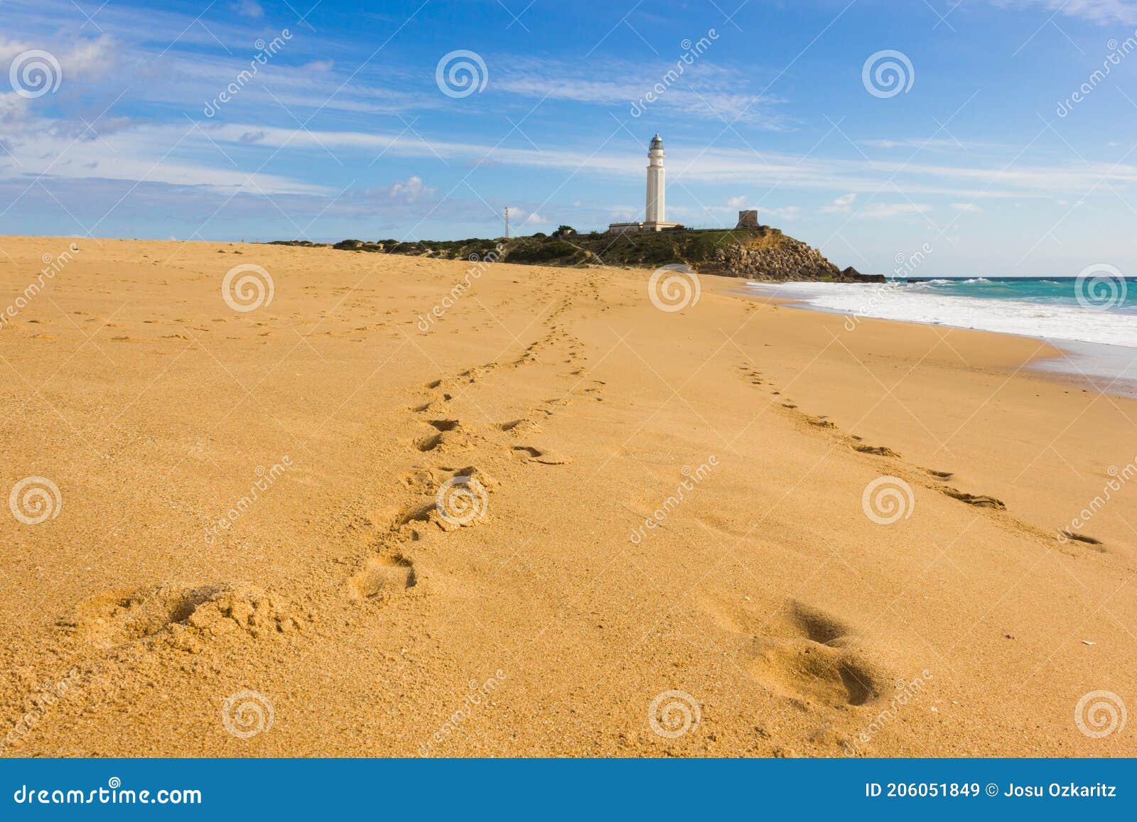 footsteps on the sand at zahora beach leading to trafalgar lighthouse