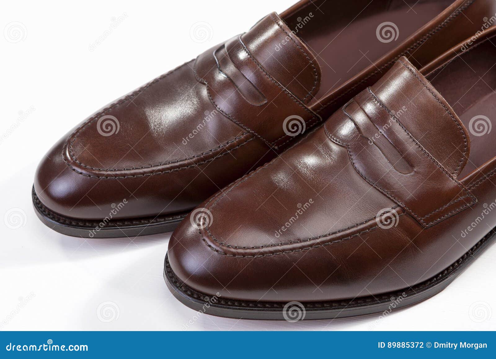 footwear . extreme closeup of leather stylish brown penny loafers