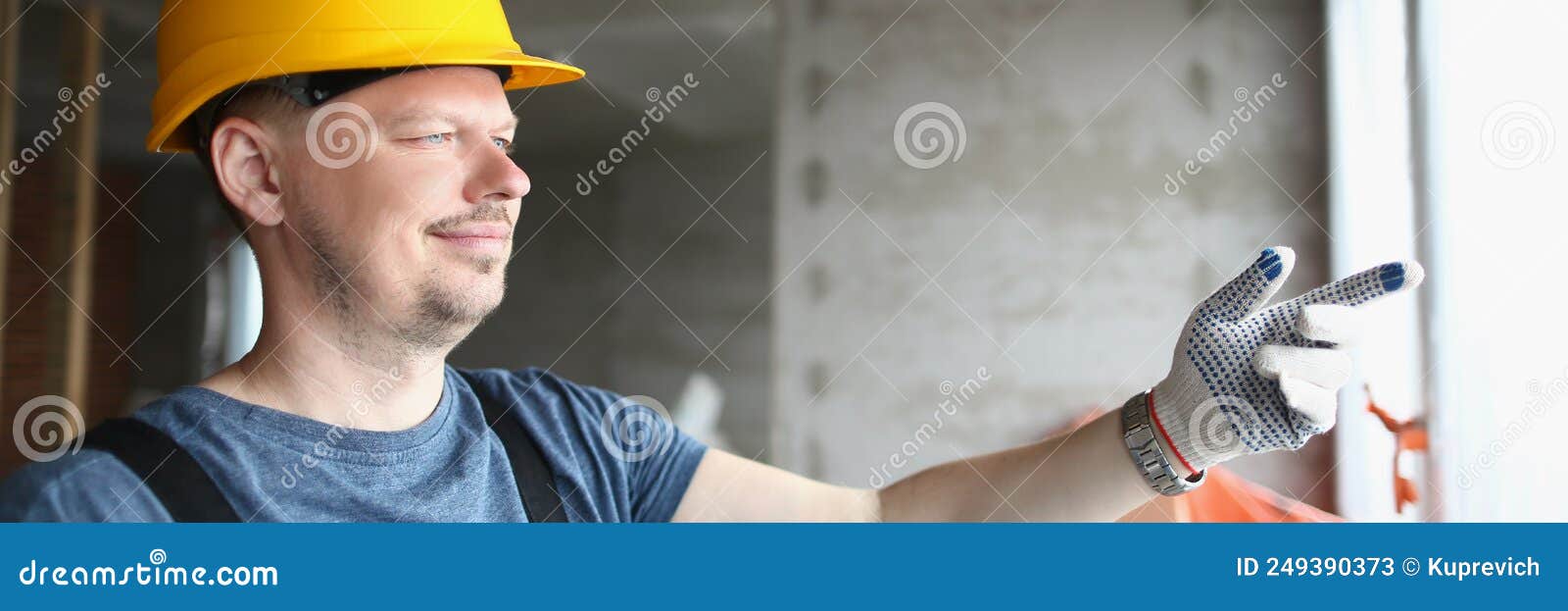 foreman holding building plan and pointing outside window to look at business complex