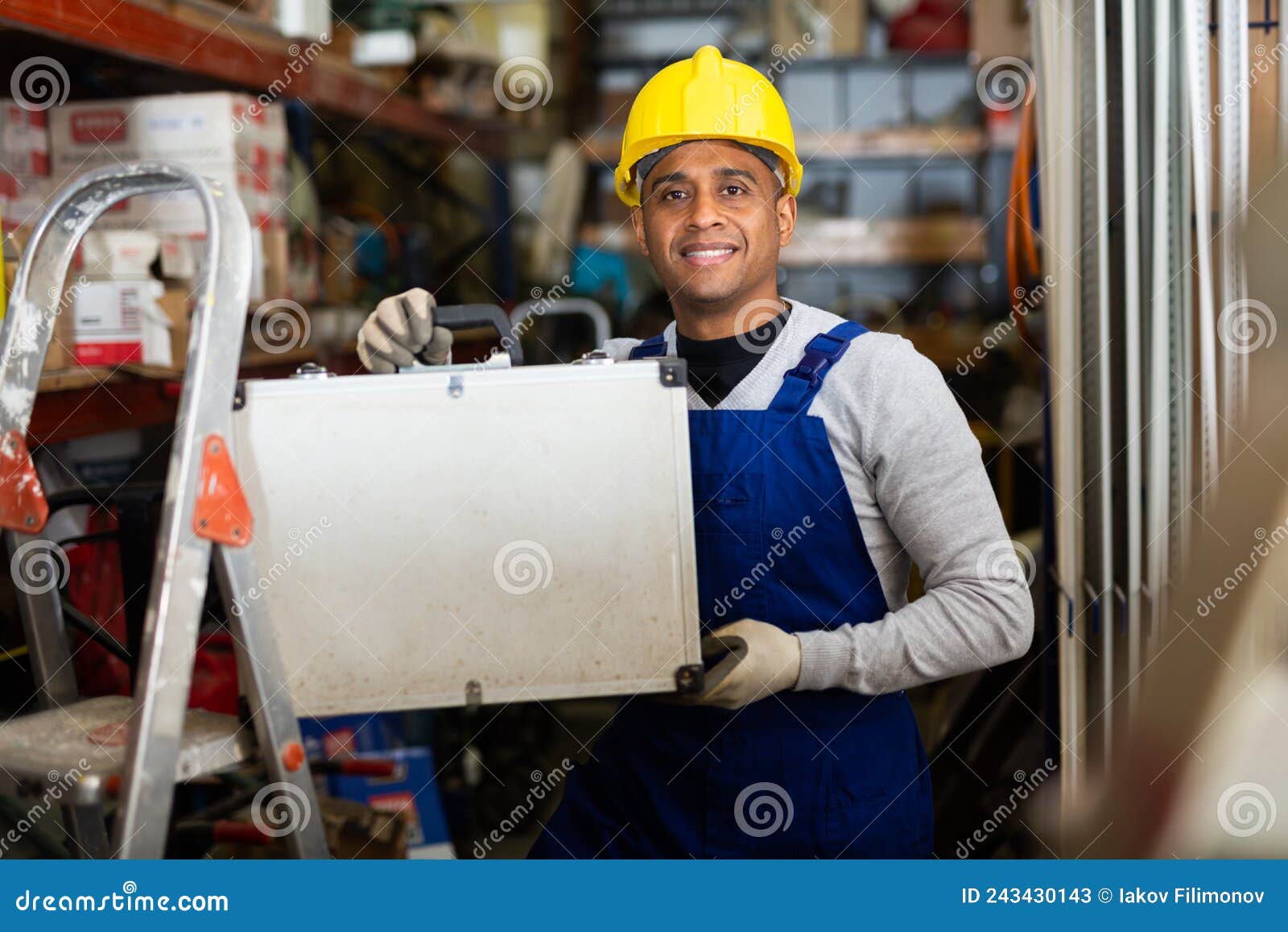Foreman in Protective Helmet and Overalls with Toolbox in Hardware