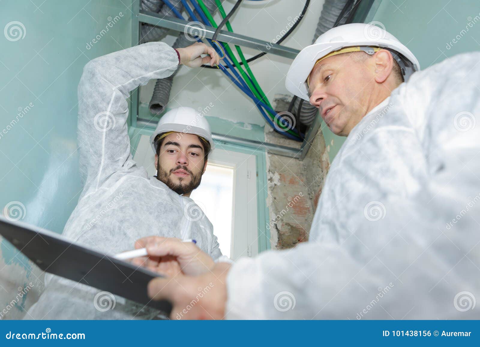 Foreman Showing Design To Electrician Stock Photo Image of energy