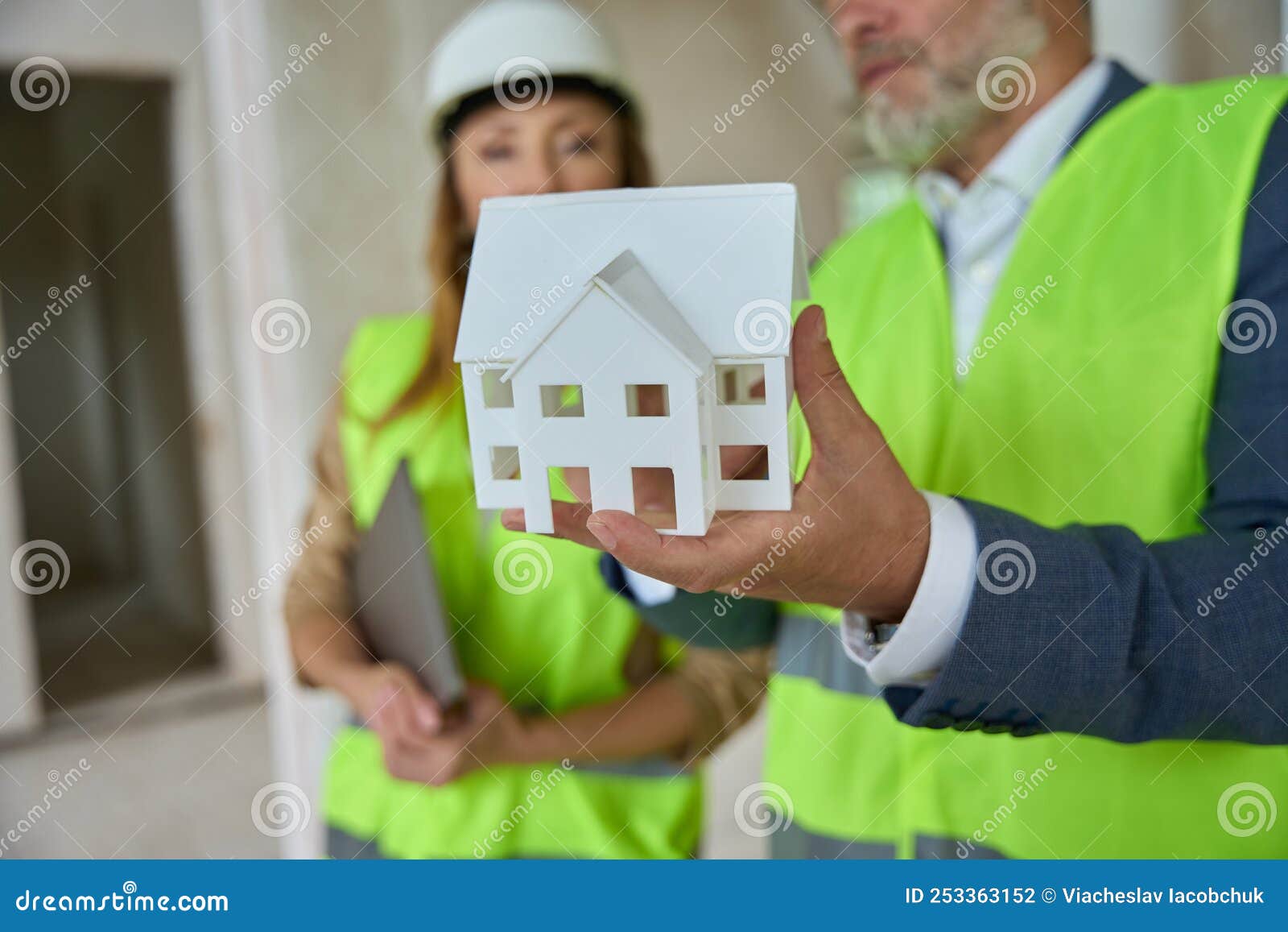 Foreman Shows Real Estate Manager a Miniature House. Construction