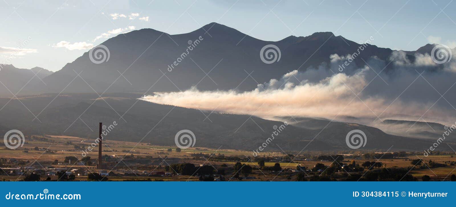 forest fire control burn with smoke drifting at sunset in salida colorado usa