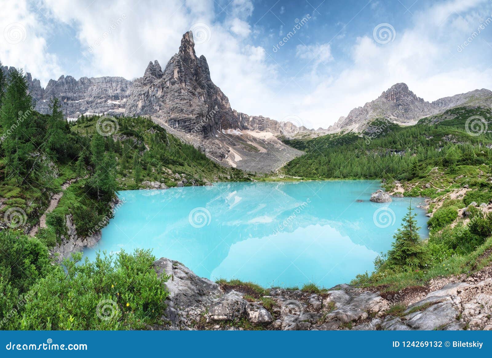 forest and turquoise lake in the dolomites apls, italy.