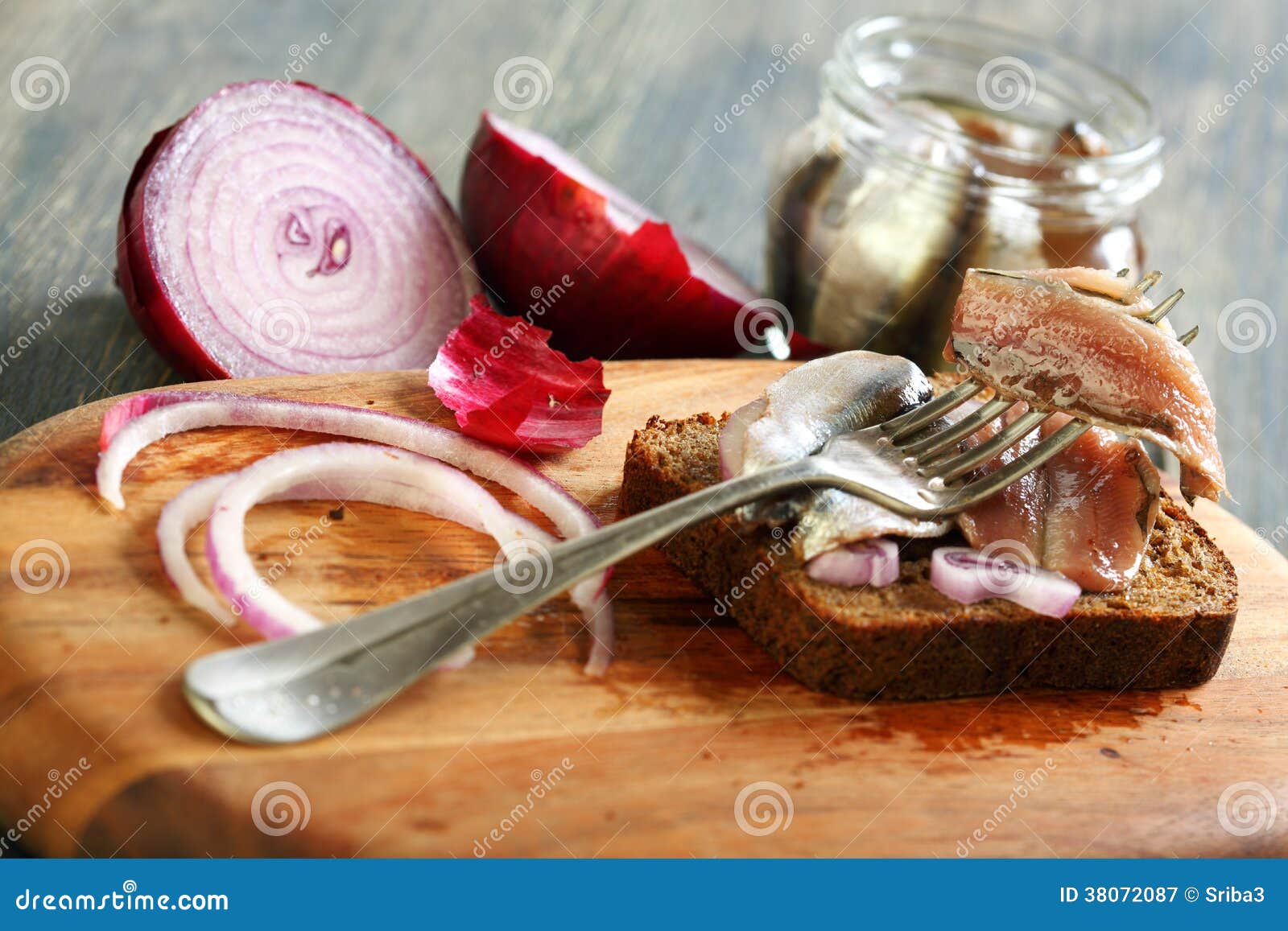 Fork with Anchovies, Rye Bread and Red Onion. Stock Image Image of