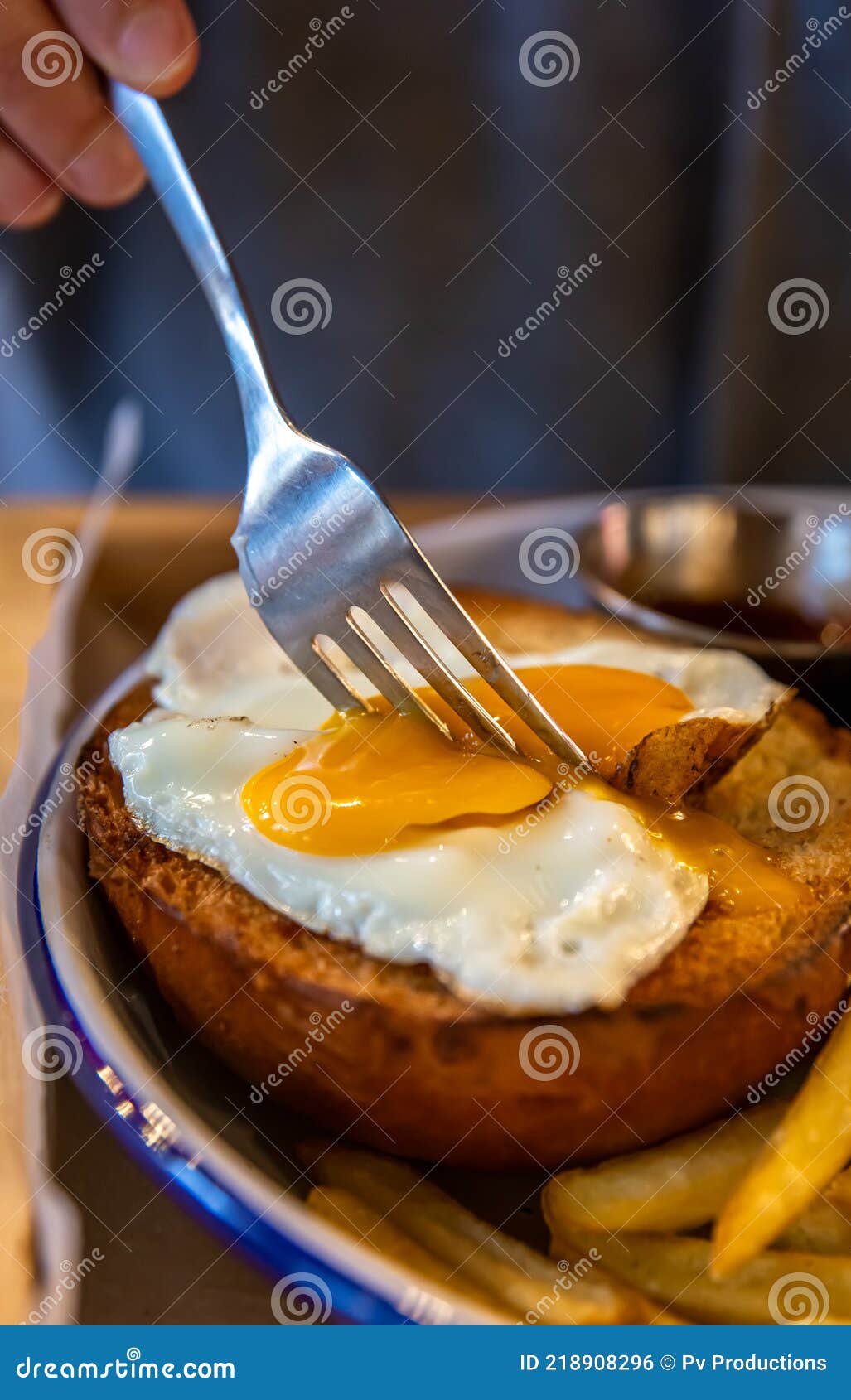 A Fork Cuts the Egg Yolk on a Burger Bun Closeup Stock Photo Image of lunch, hamburger 218908296