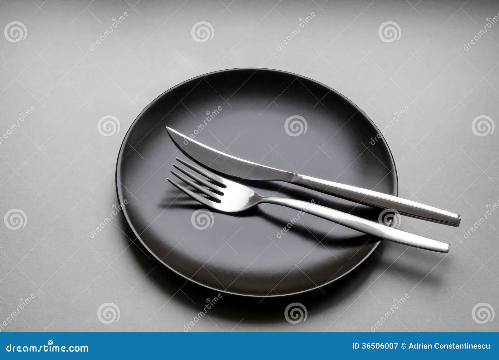 Fork and Knife on a Black Plate Stock Image Image of utensils, silver