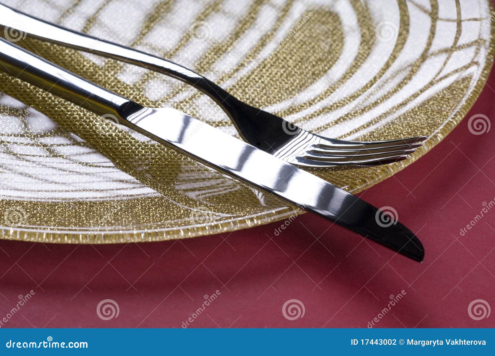 Fork and knife on a plate stock photo. Image of close 17443002