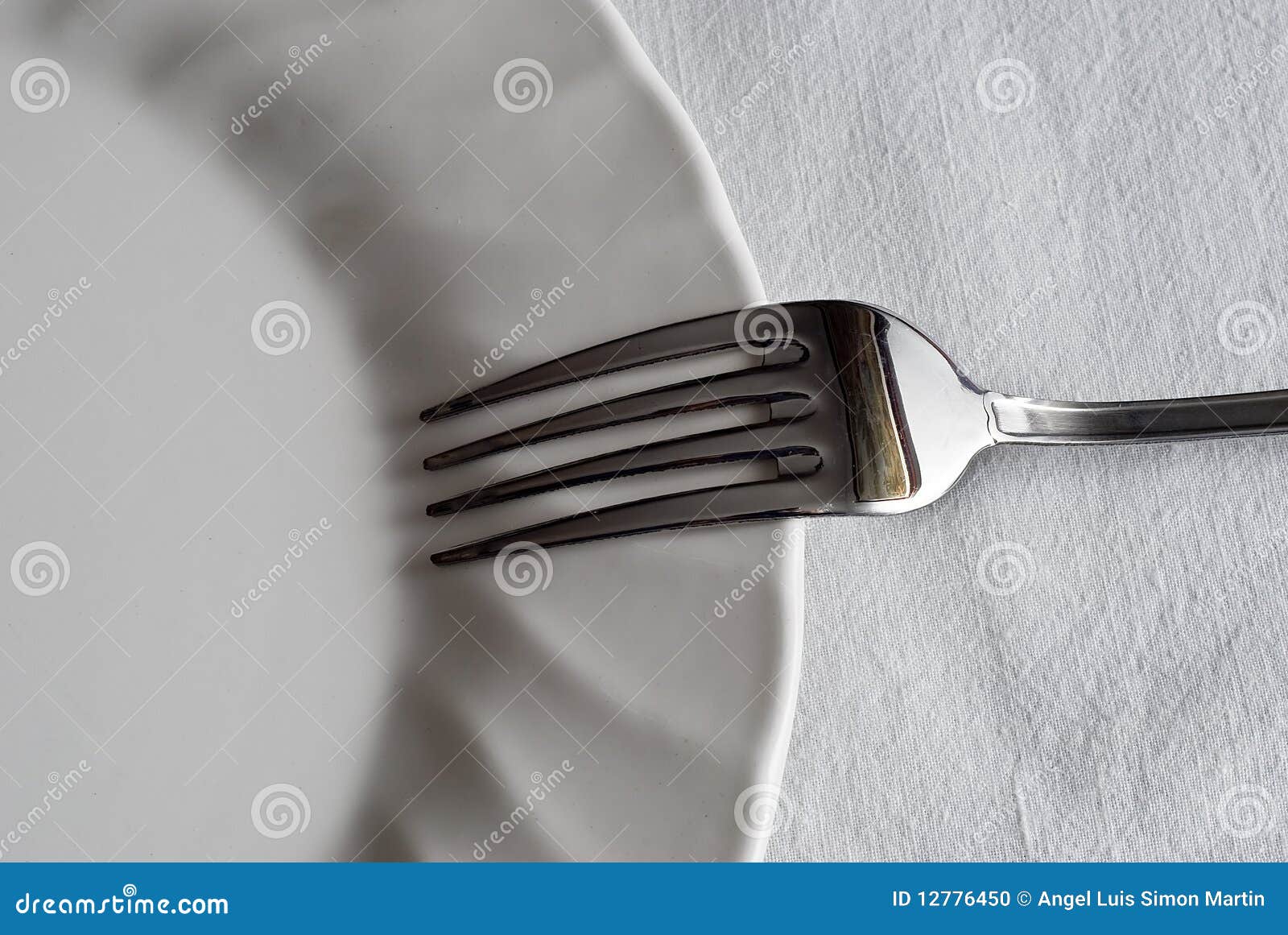 Fork on the plate. stock photo. Image of place, tablecloth 12776450
