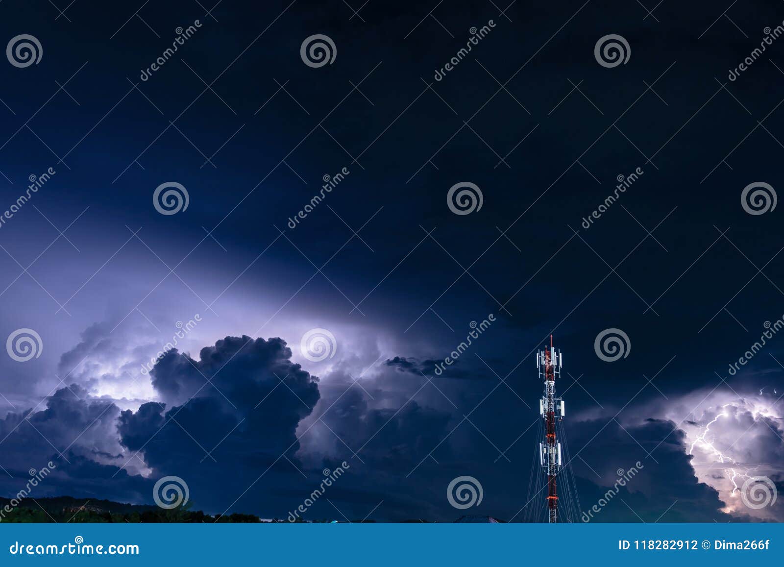 Forked Lightning Over the Cell Phone Antenna Tower at Night Stock Photo