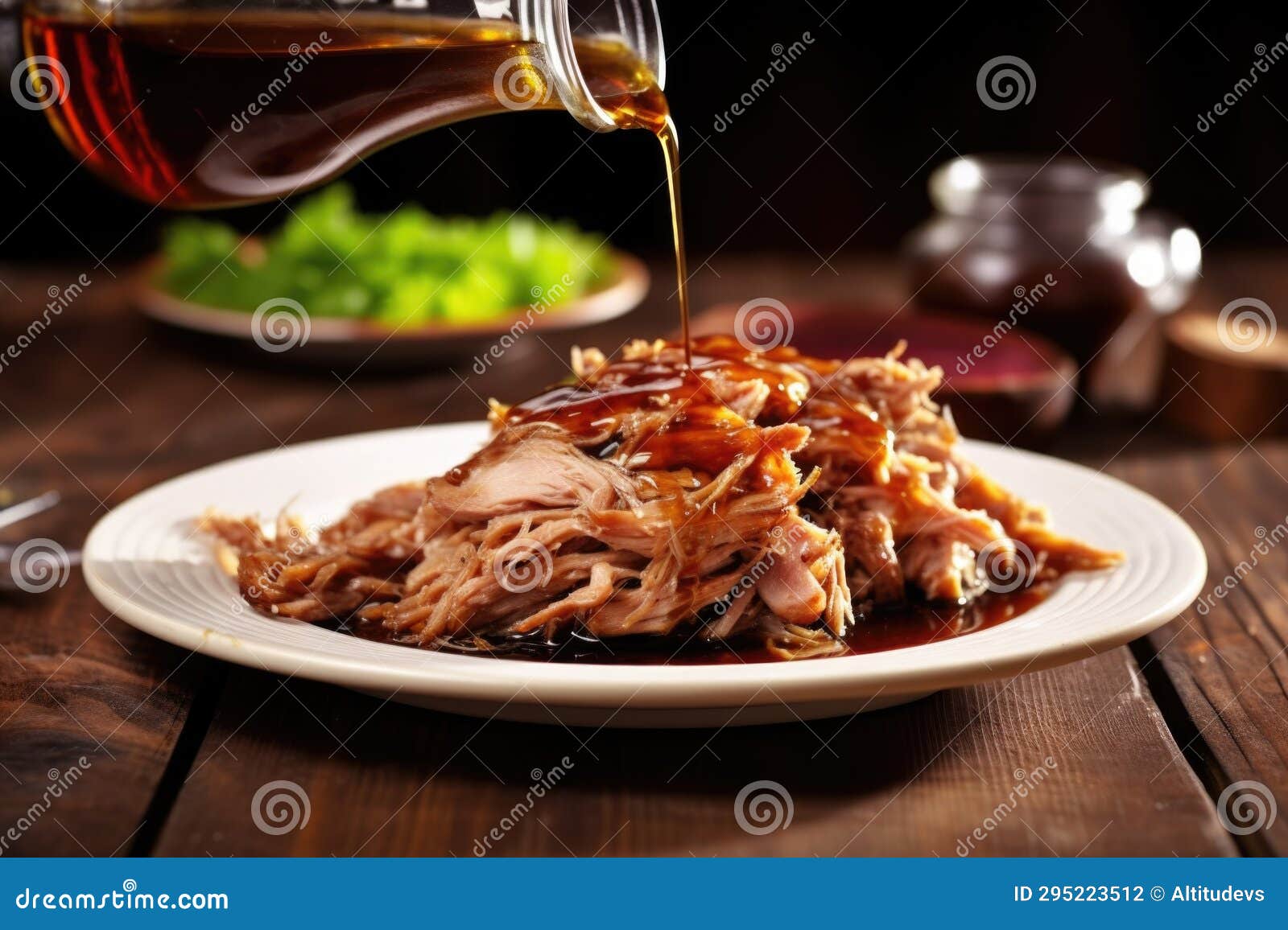 Forkful of Pulled Pork Drenched in Vinegar Sauce Over a Plate Stock