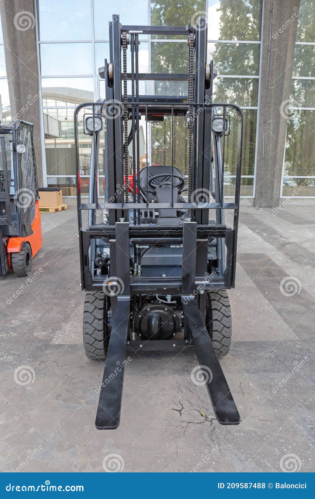 Forklift Leg In Front Of Pallet Stacking In The Loading Warehouse Dock