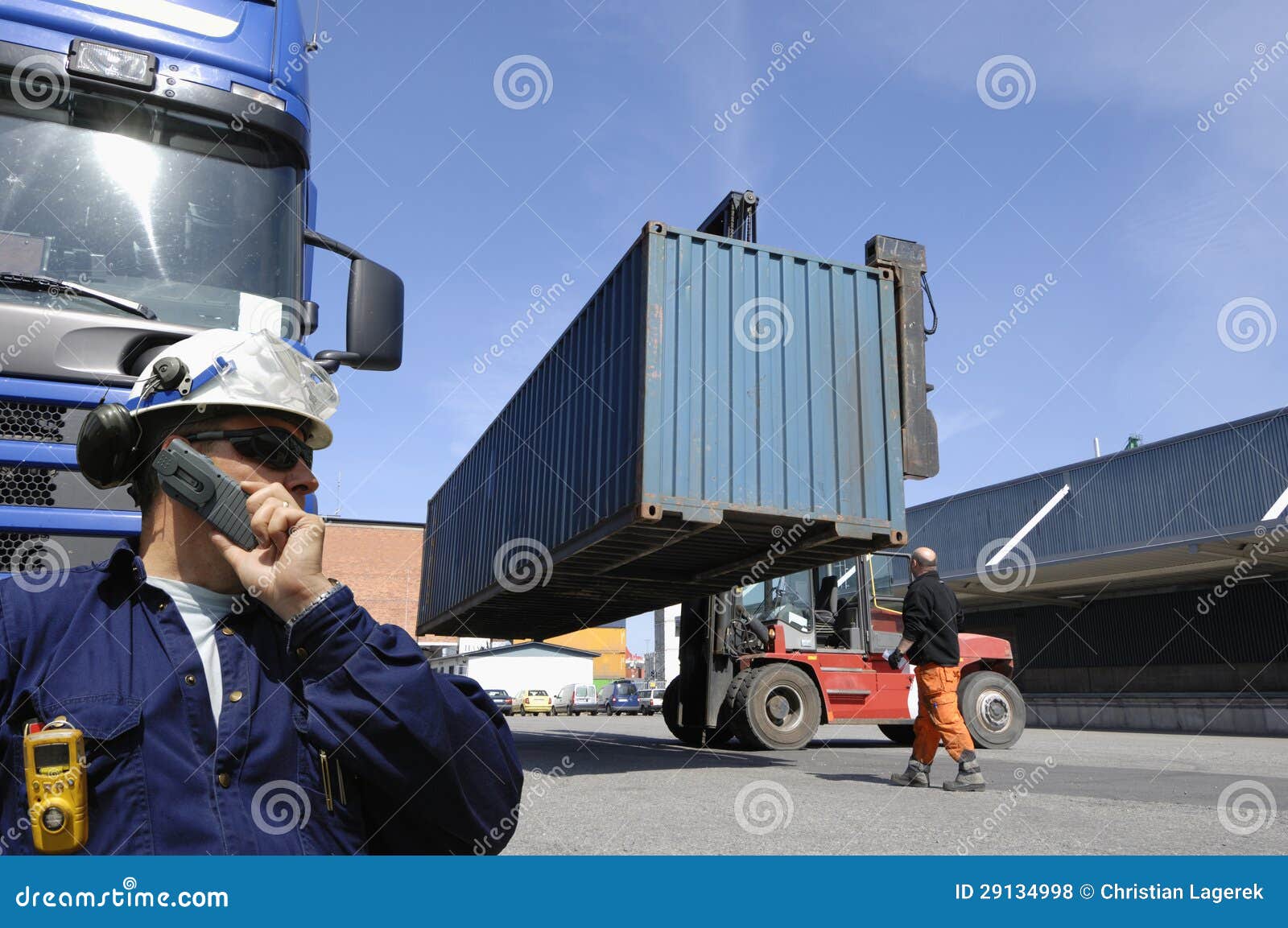 forklift hoisting cargo and shipping containers