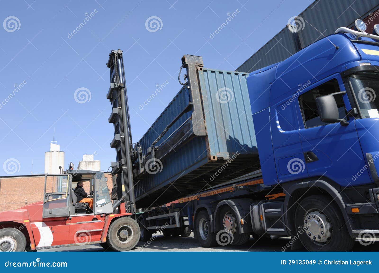 forklift hoisting cargo and shipping containers