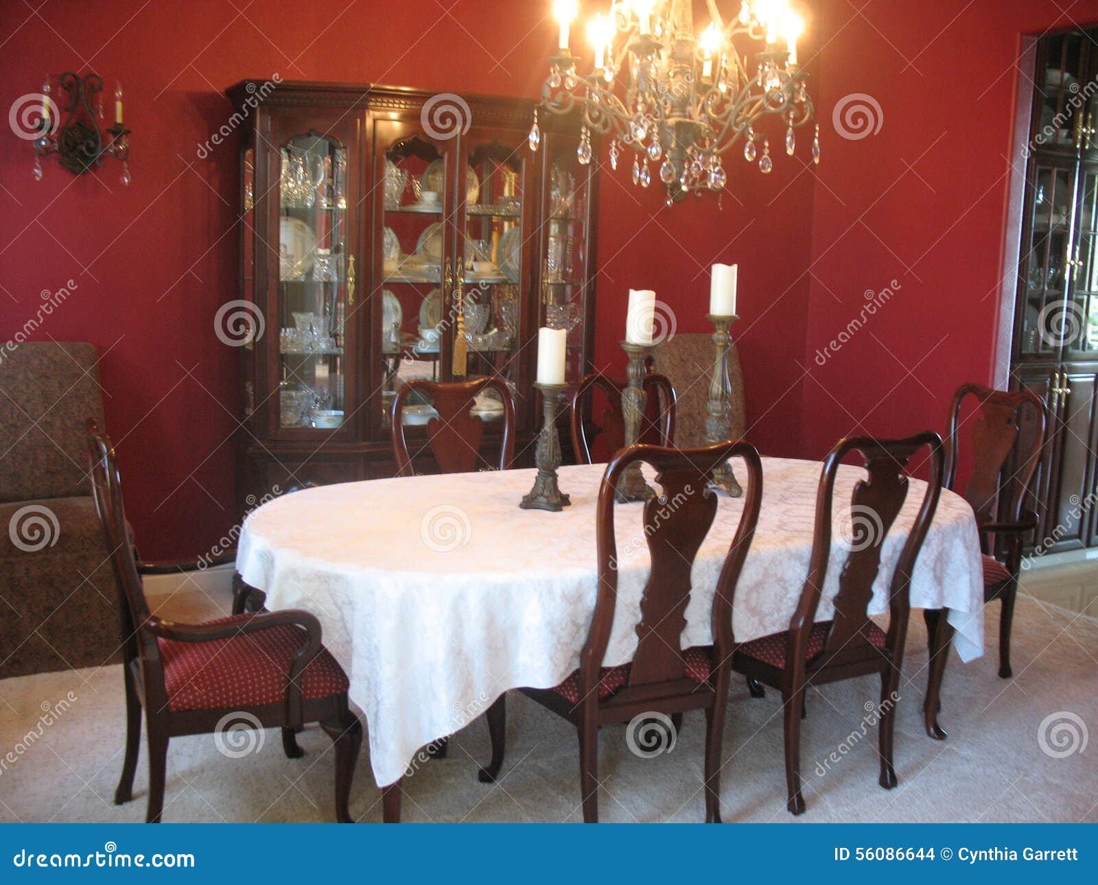 Formal Dining Room With China Cabinet And Chandelier Stock Photo