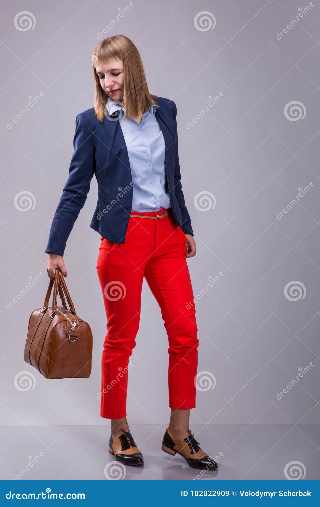 Forme La Mirada De Pantalones Rojos Vestidos Mujer, Chaqueta Azul, Bolso Marrón El Mira Un Bolso De Cuero Altura Completa Imagen archivo - Imagen de bolso, viaje: 102022909