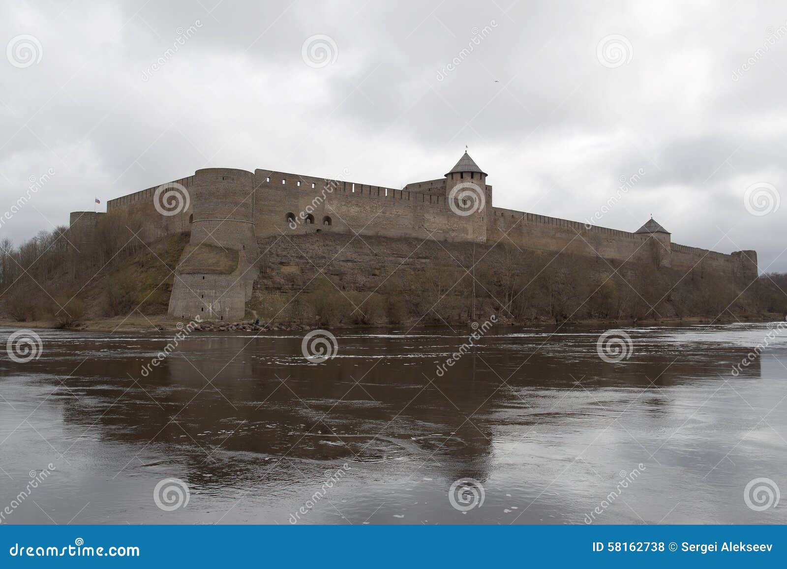 A fortaleza de Ivangorod do russo situada atrás do rio de Narva na frente do castelo estônio de Hermann