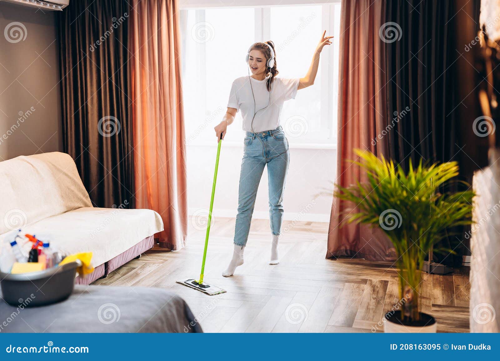 Mano de mujer sosteniendo un trapeador limpieza piso de la casa.