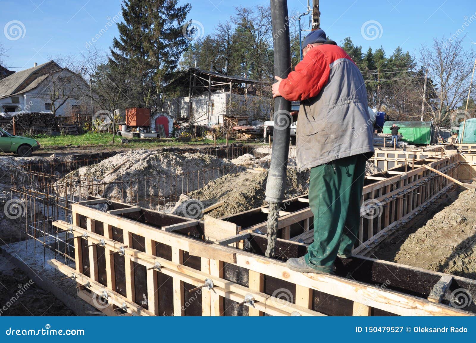 Foundation Construction. Builder Contractor is Pouring a Building