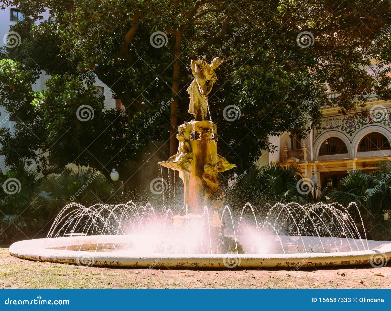 fountain at gabriel miro plaza in spanish city of alicante at costa blanca surrounded by green palm trees historical landmarks
