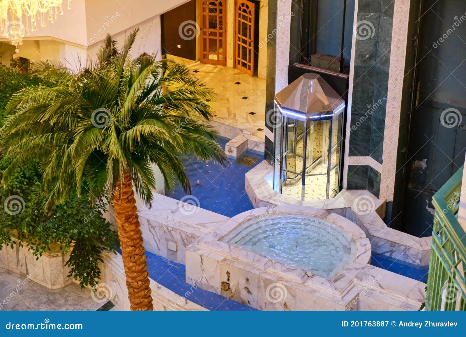 Fountain, Palm Tree and Elevator in the Lobby Hotel Editorial Photography Image of hotel