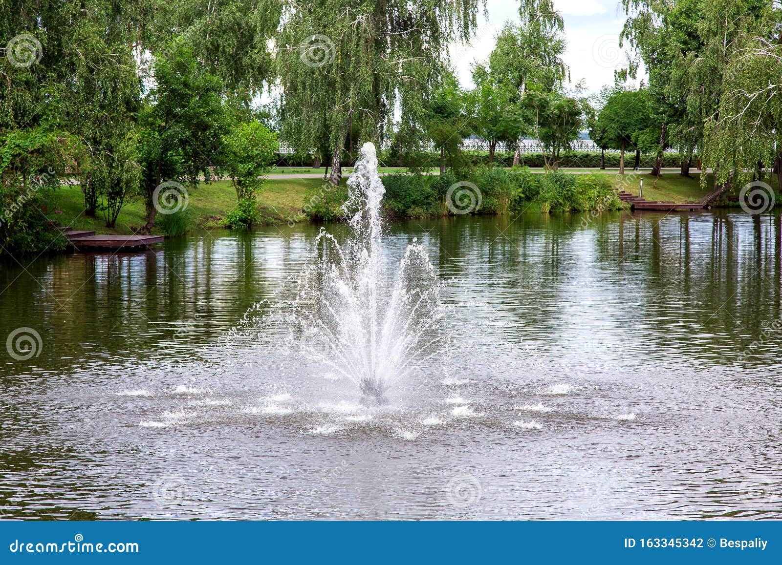 Fountain in the Pond on the Park. Stock Photo Image of cloudy