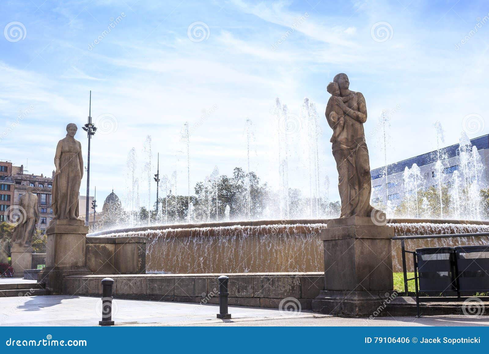 fountain with sculptures on placa de catalunya, barcelona, spain