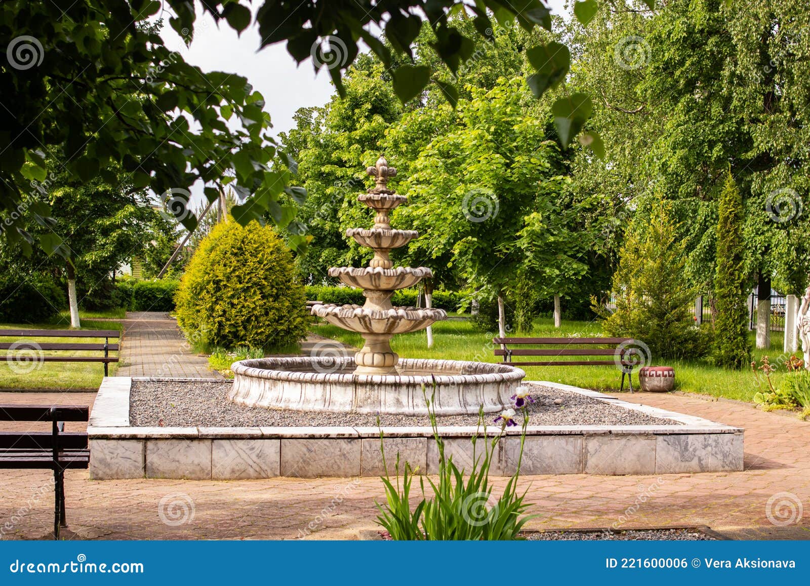Fountain Statue in Park Against Background of Green Bushes Stock Photo ...