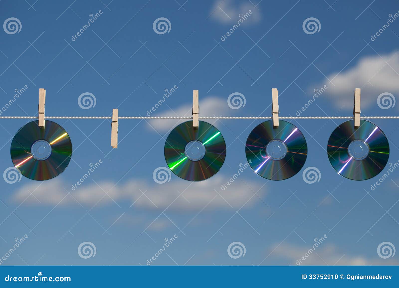 four cds on a clotheslines