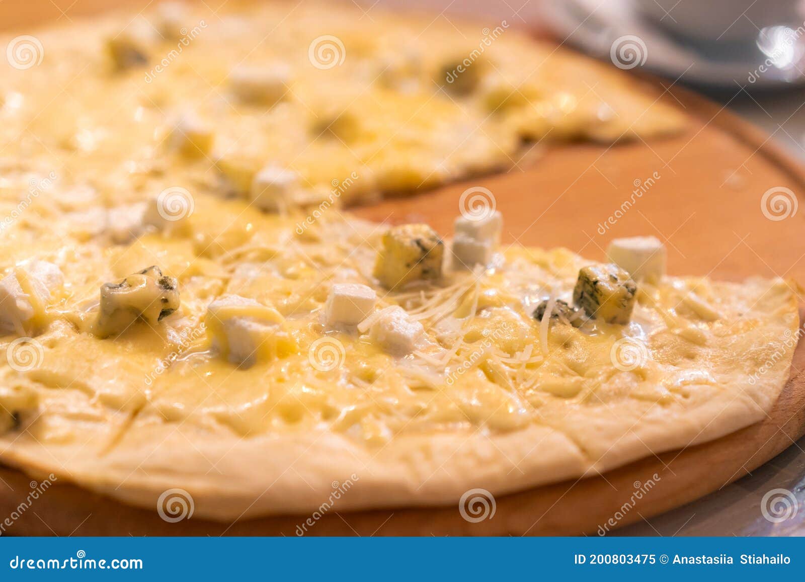 Four Cheese Pizza. Pizza Stuffed with Four Varieties of Cheese on a