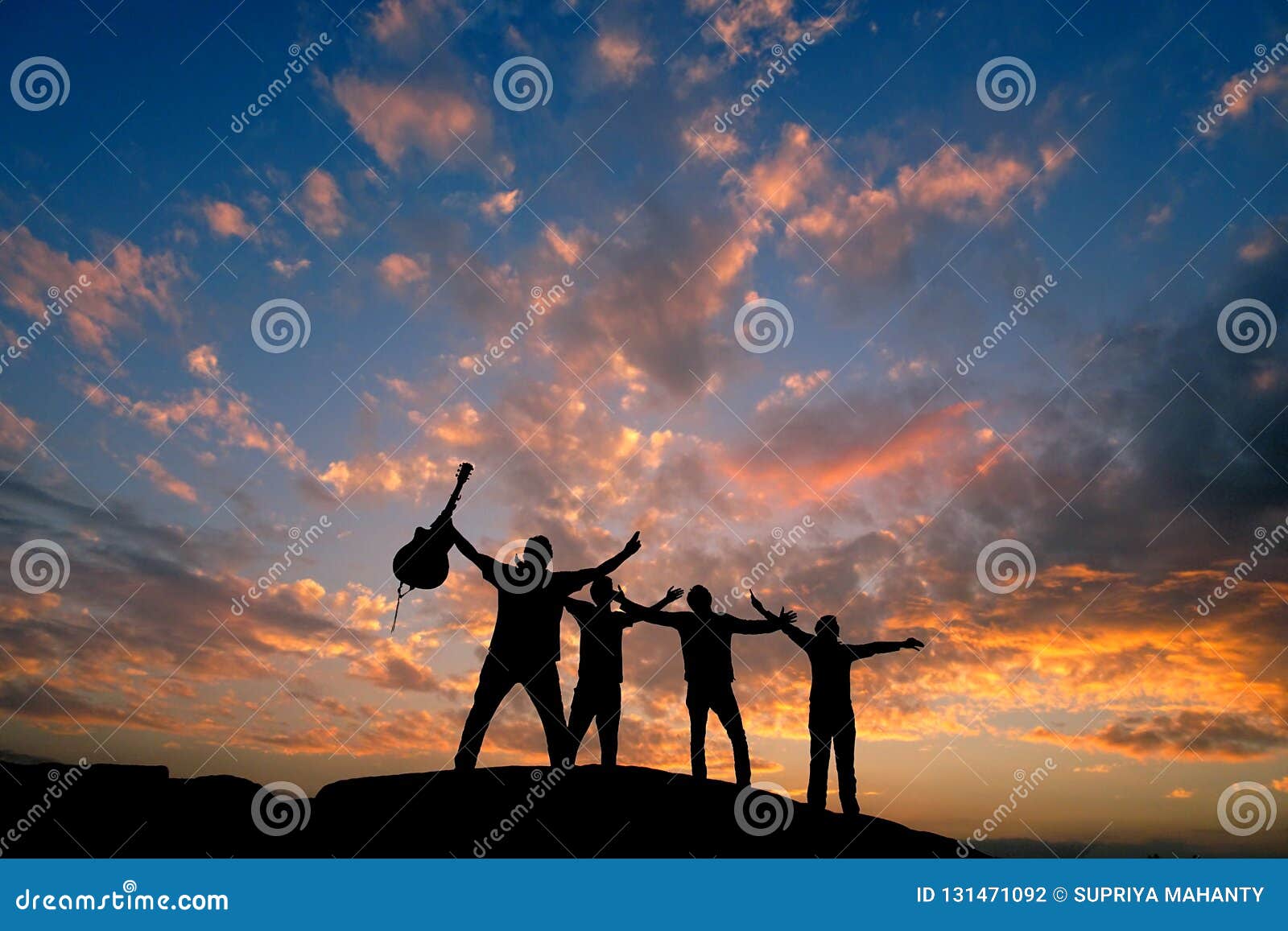 Four Friends Silhouette on Top of a Hill with Guitar Stock Photo ...