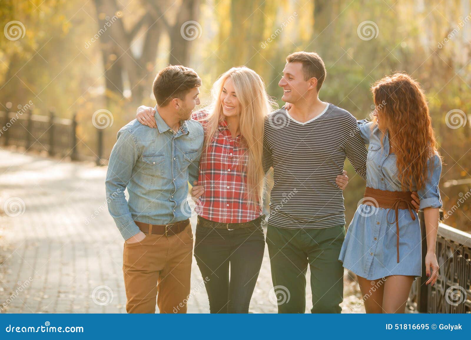Four Good Friends Relax and Have Fun in Autumn Park. Stock Image ...