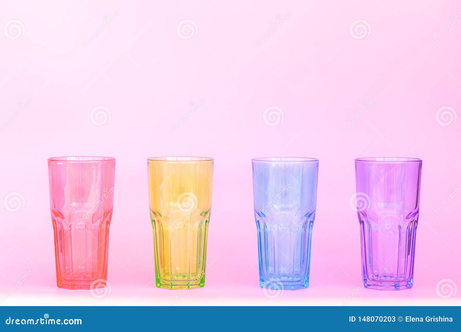 Four Identical Glass Glasses Red Green Blue Purple Stock Image