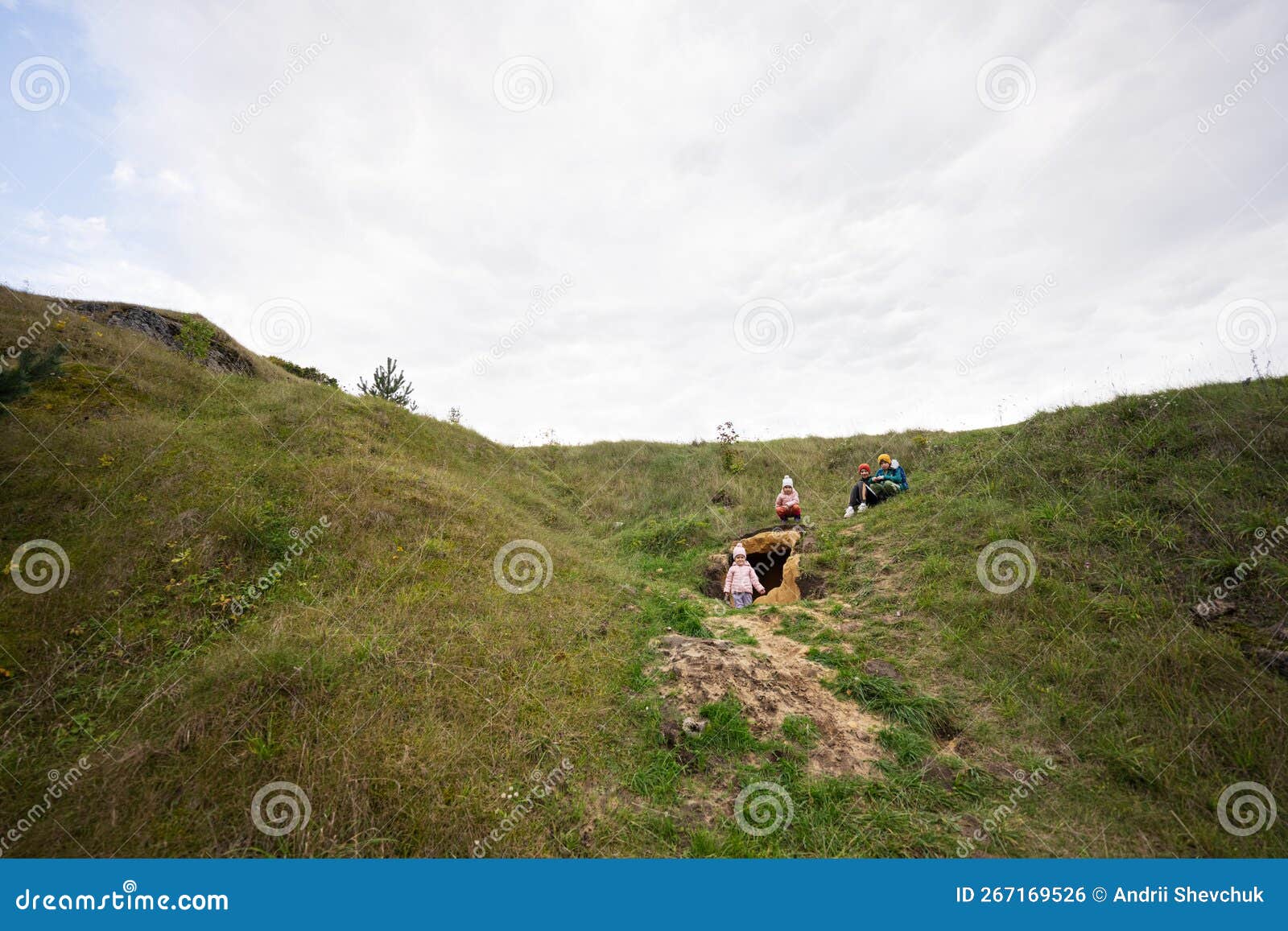 Four Kids Explore Limestone Stone Cave at Mountain Stock Photo Image