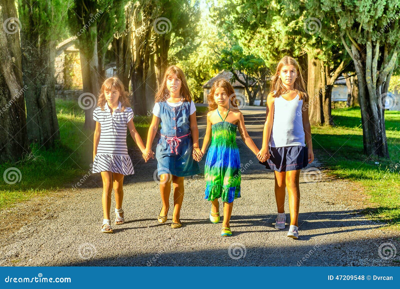 Four Little Girls Walking through the Park Stock Photo Image of