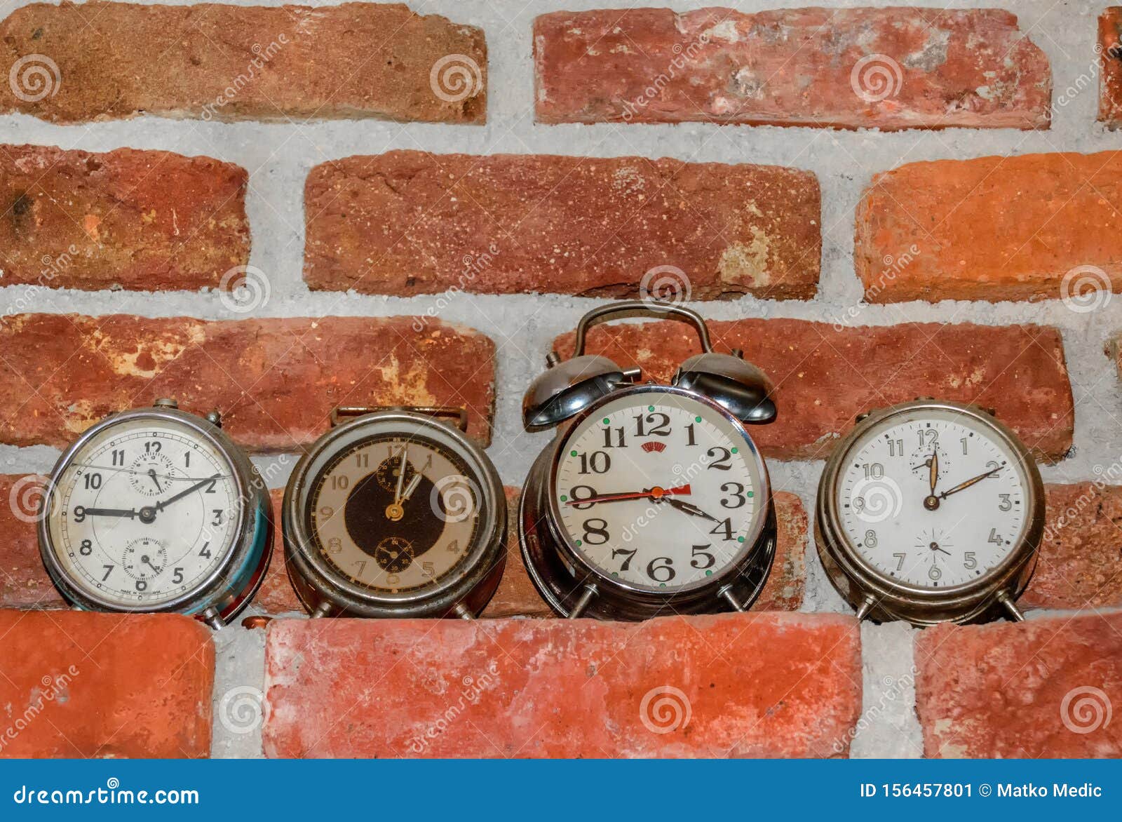 Four Old Clocks on the Brick Wall Shelf Stock Image Image of wall