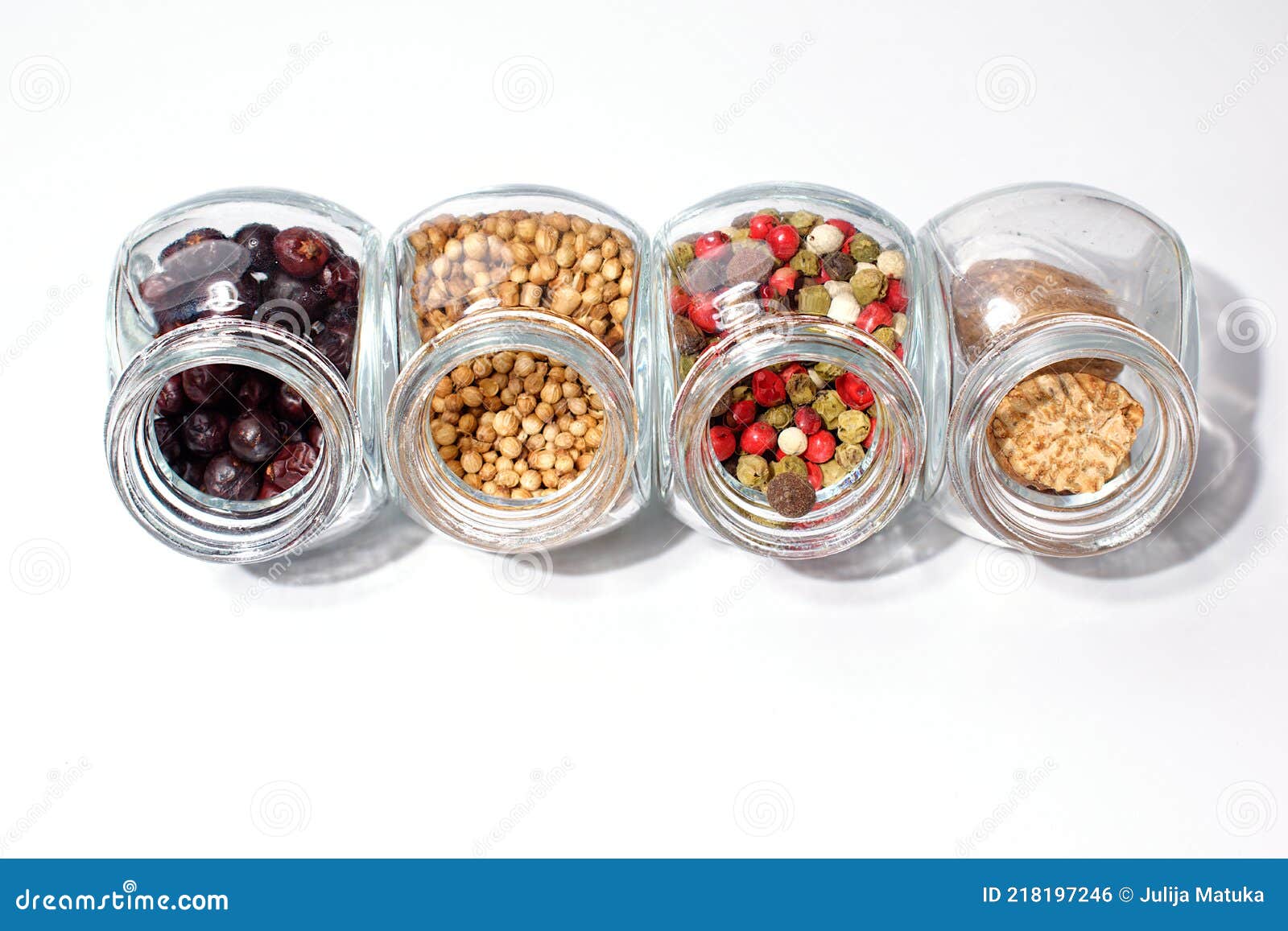 Four Open Glass Jars of Condiments. a Mixture of Five Peppers