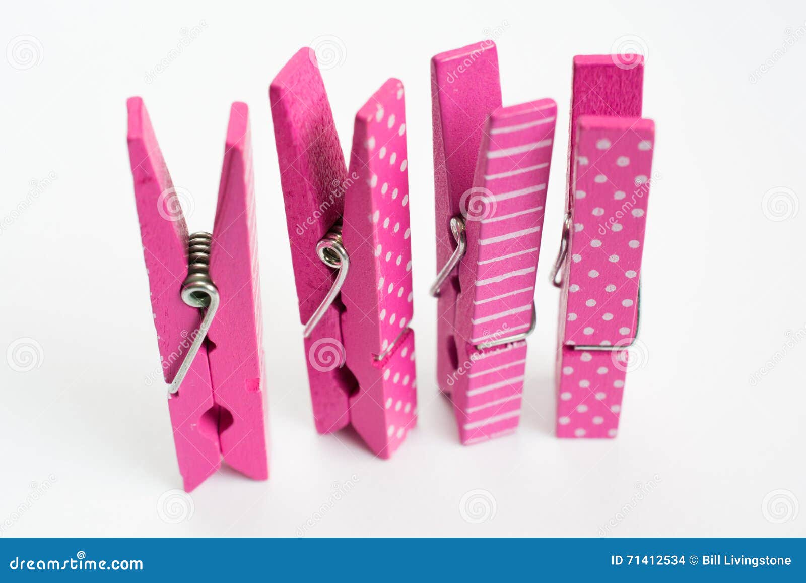 Four Pink Clothes Pins with Fun Patterns Standing Up Angled Front