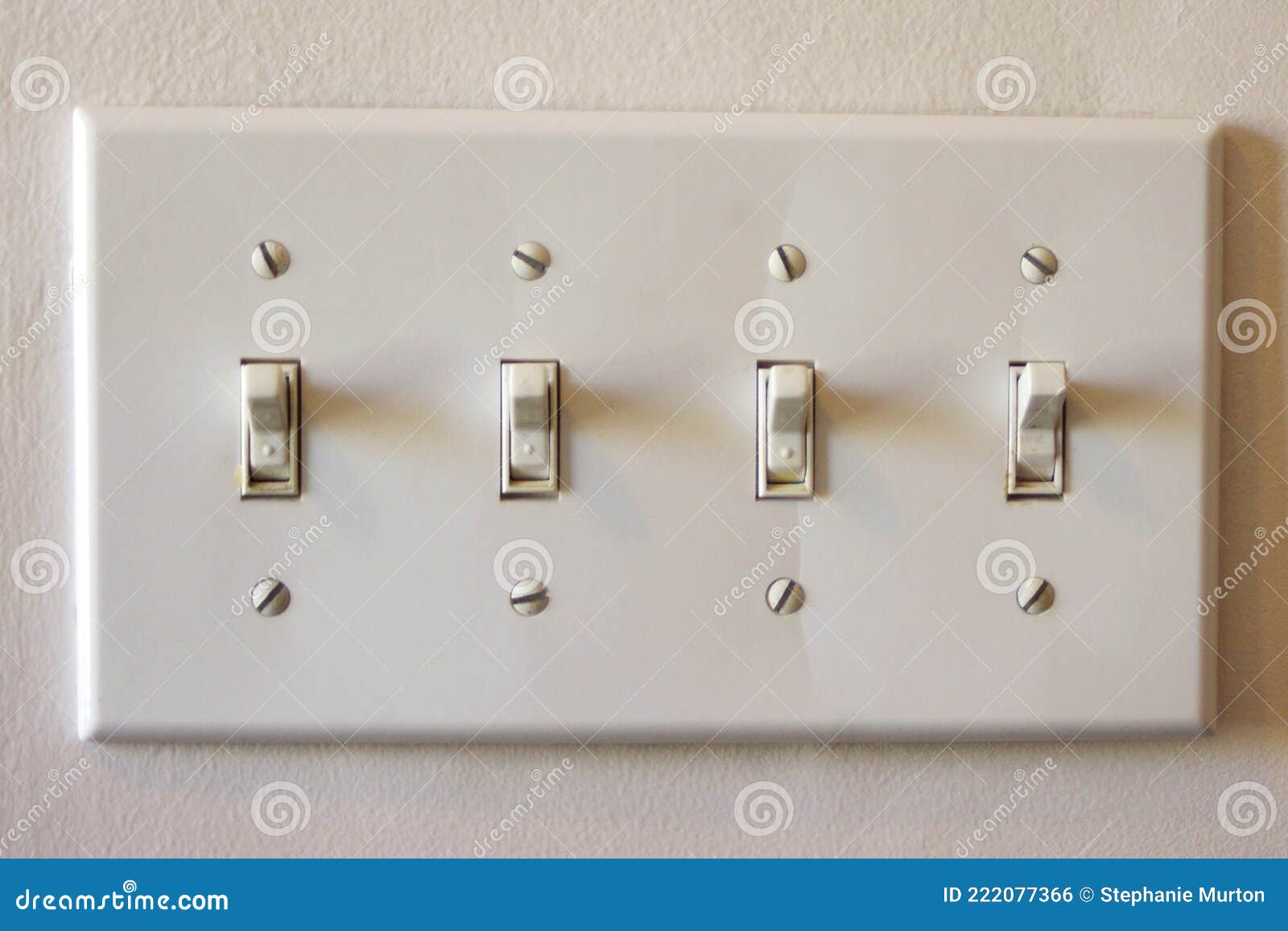 Four Plastic Light Switches on Wall Set To on Stock Photo Image of