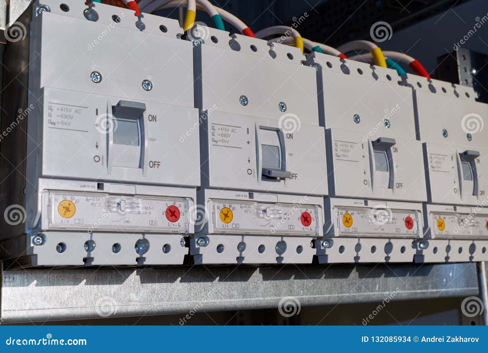 Four Power Circuit Breakers Are Fixed In The Electrical Cabinet In