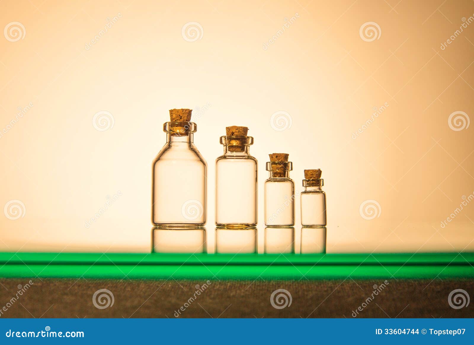 Four Size of Glass Bottles on Yellow Background Stock Photo Image of